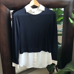 Navy blue sweater with dress shirt detail.